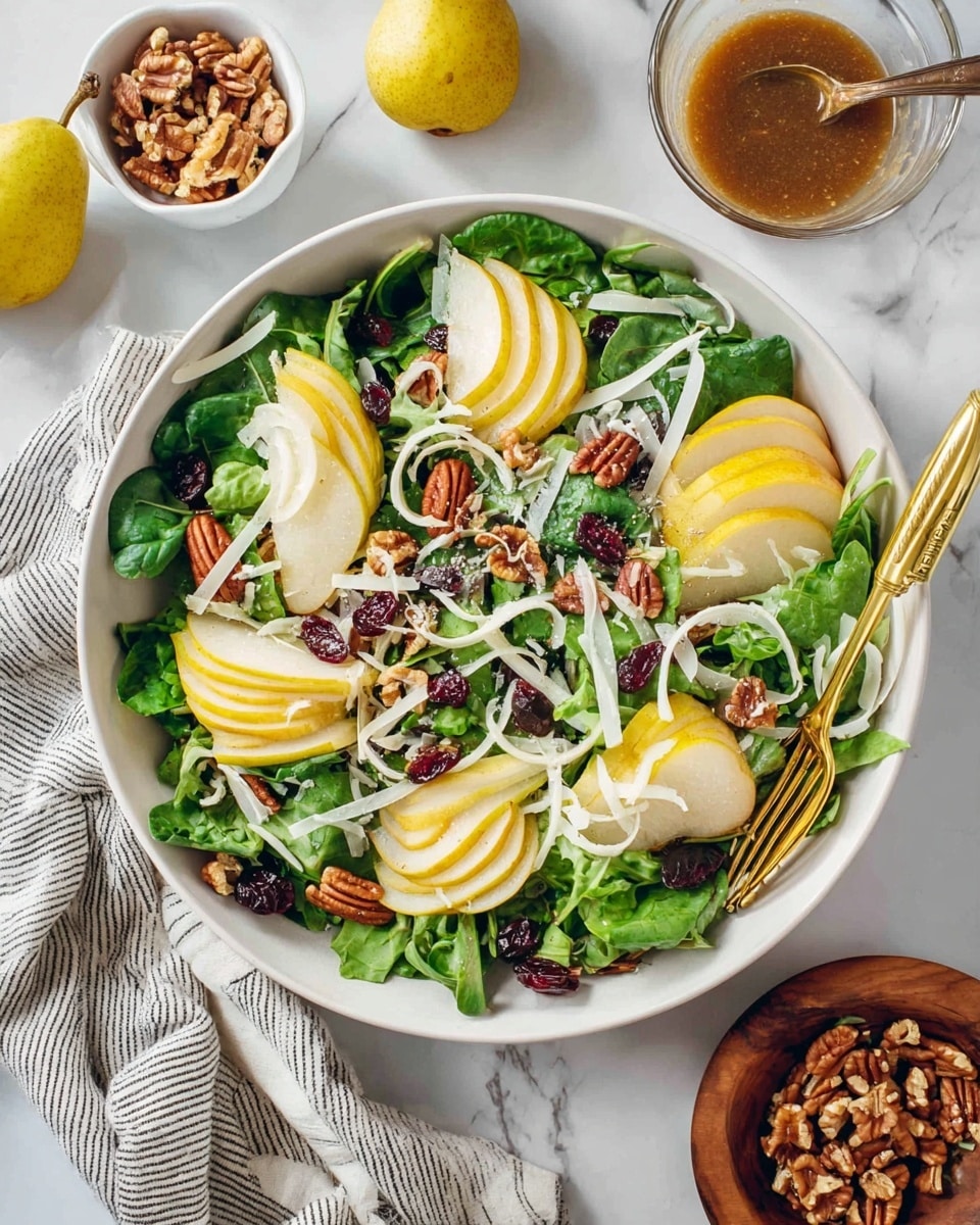 A fresh salad is shown in a large white bowl placed on a white marbled surface. The salad layers start with a base of green leafy mix including baby spinach and kale. Over them are thin slices of yellow pear arranged in small groups across the bowl. Scattered on top are pecan halves and small bits of dried cranberries, adding a dark reddish brown color. Thin wide curls of white cheese are spread irregularly over the salad. There are also some thin slices of white onion adding a slight translucent texture. A gold salad tong rests on the edge of the bowl, slightly open. Around the bowl, a small clear glass bowl with a brown dressing and a spoon, a wooden small bowl with walnuts, and a white small bowl with more pecans are visible. Two whole yellow pears lie near the bottom left corner. A soft cloth with thin black stripes is tucked beside the bowl. The photo taken with an iphone --ar 4:5 --v 7
