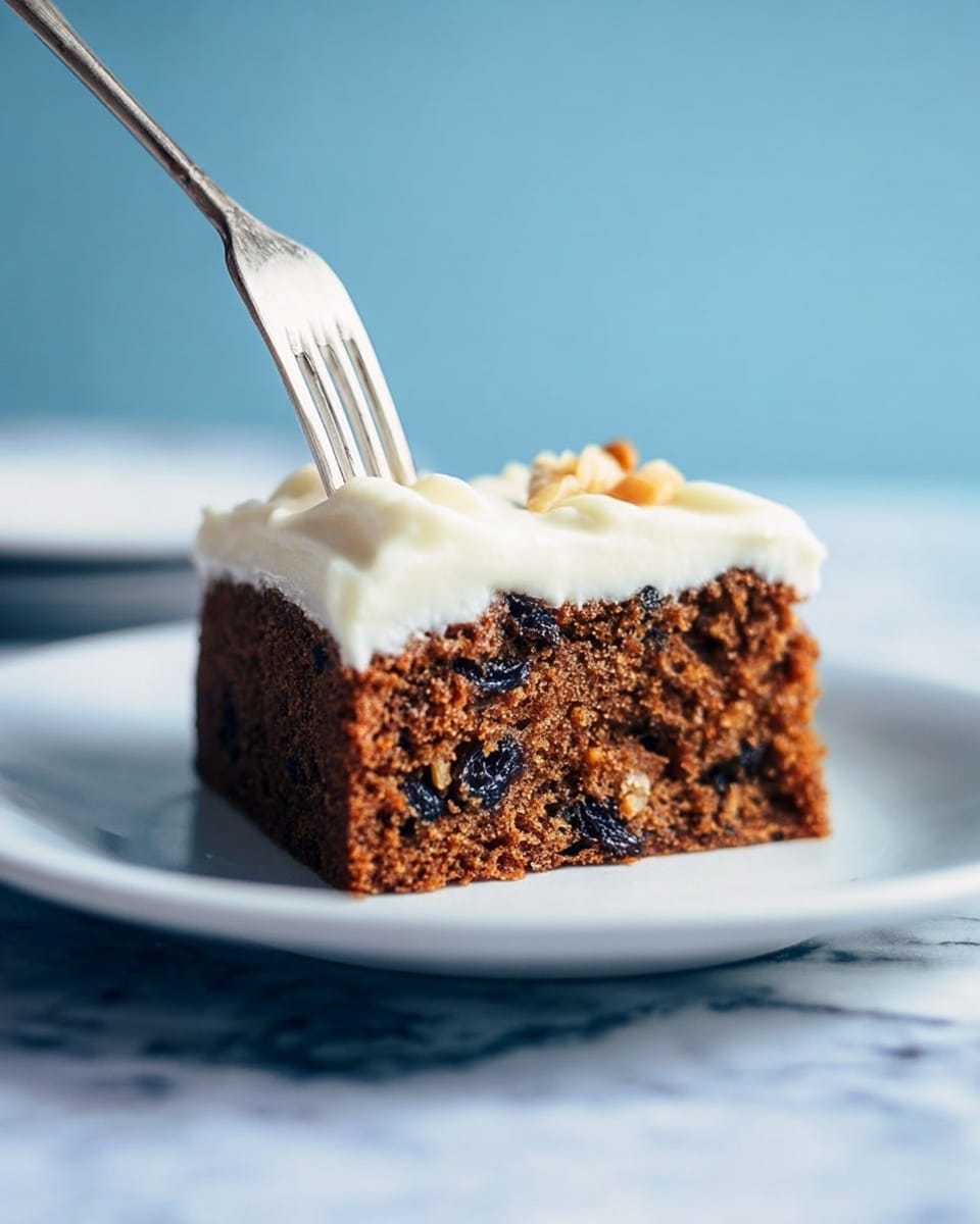 A piece of brown cake with visible dark spots of nuts and raisins is placed on a white plate. The cake has one thick layer of soft white frosting on top, with a fork gently pressed into it from above. The background is a soft blue color and the surface underneath the plate is a white marbled texture. Photo taken with an iphone --ar 4:5 --v 7