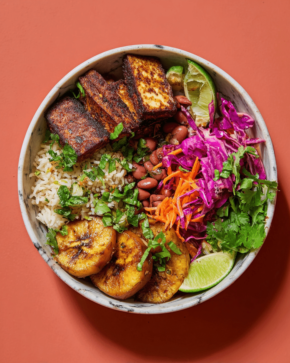 A round bowl with four main sections: at the bottom left, a mixture of white rice and red beans with some green herbs sprinkled over; at the bottom right, several golden brown, caramelized fried plantain slices with a slightly crispy texture; at the top right, a colorful slaw made of bright purple cabbage and thin orange carrot strips, garnished with green herbs; and at the top left, five thick slices of grilled tofu with a dark, crispy char on the edges, accompanied by two lime wedges and fresh cilantro leaves scattered over the whole bowl, all set against a white marbled texture background. photo taken with an iphone --ar 4:5 --v 7