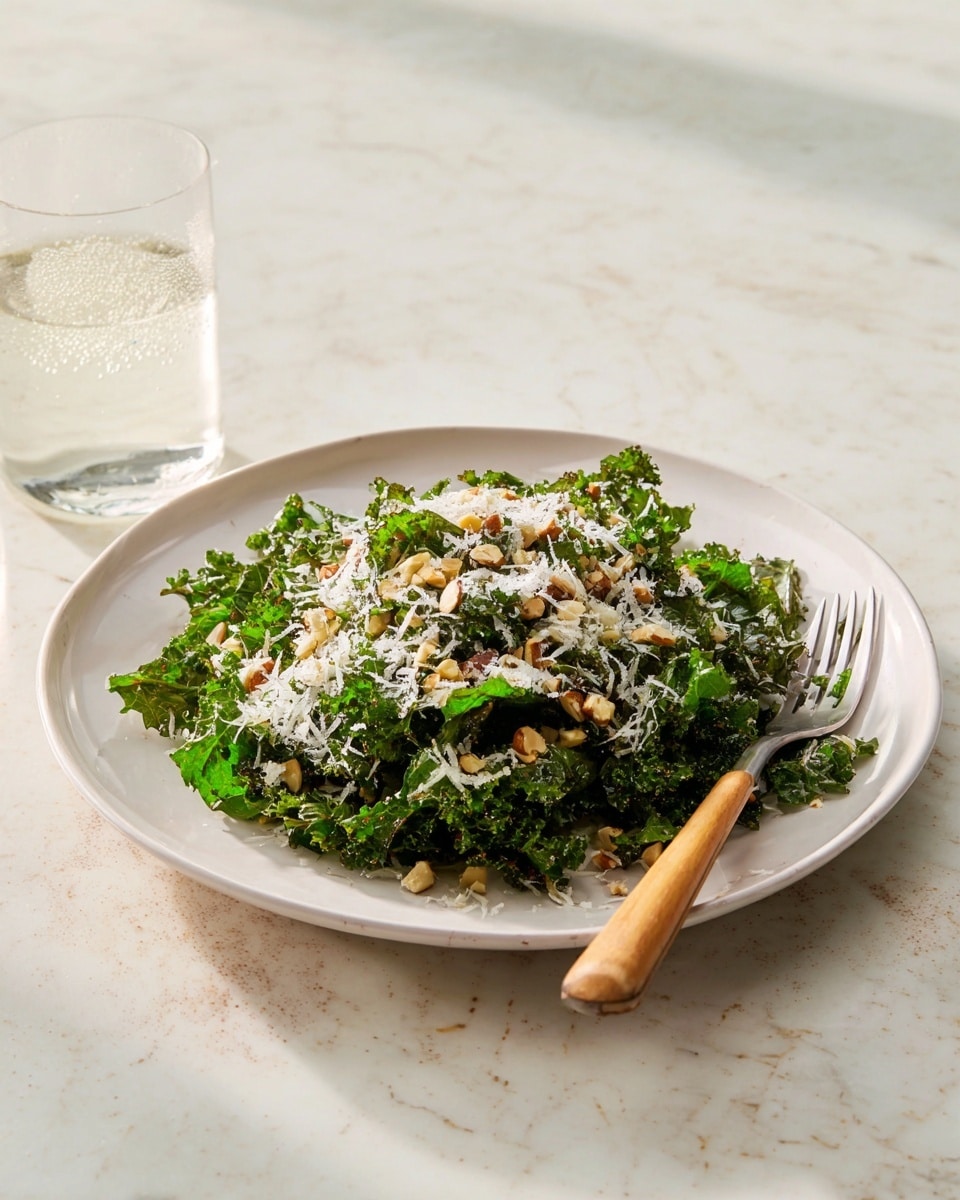The dish shows a close-up of several crispy, golden-orange baked or fried slices stacked on a base of dark green kale leaves, creating a contrast between the crunchy texture and the fresh, leafy greens. Over the top, unevenly broken light cream-colored cheese shavings are scattered, adding a layer of sharpness and color brightness. A light drizzle of creamy off-white sauce with specks of black pepper is lightly spread across the layers, enhancing the textures and creating a slight shine. The whole arrangement rests on a white marbled texture, highlighting the vibrant colors of the food. Photo taken with an iphone --ar 4:5 --v 7
