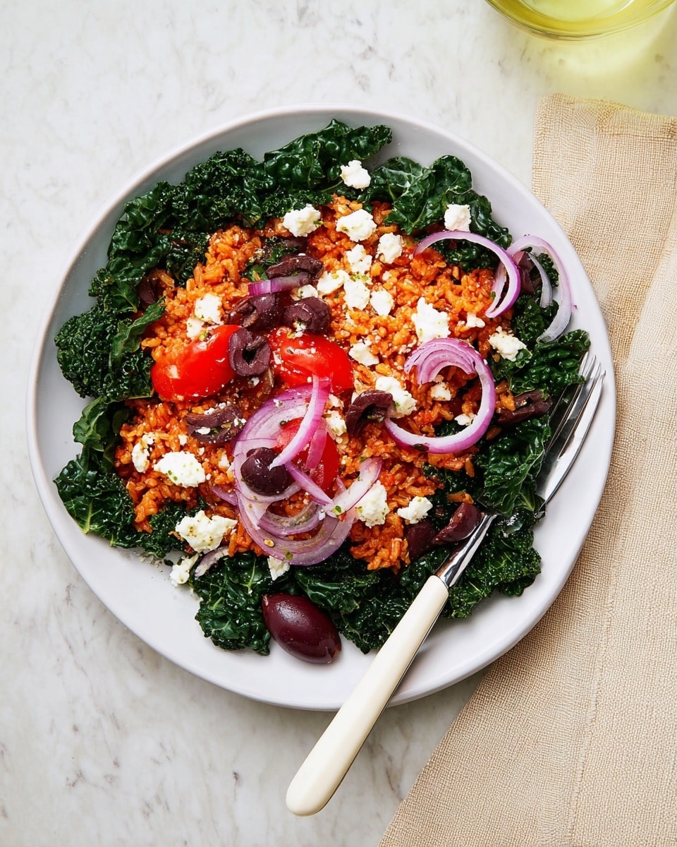 A white plate holds a layered dish starting with a base of dark green kale leaves around the edges, topped by a thick middle layer of reddish-orange seasoned rice. On top of the rice, there are small chunks of white cheese, thin crescent-shaped slices of red onion, halved dark purple olives, and small bright red tomato pieces scattered evenly. The kale leaves have a shiny texture, while the rice looks slightly moist and grainy. A white-handled fork rests at the bottom of the plate with a dark purple olive near its base. The dish is placed on a white marbled surface with a beige cloth napkin partially visible in the corner. Photo taken with an iphone --ar 4:5 --v 7
