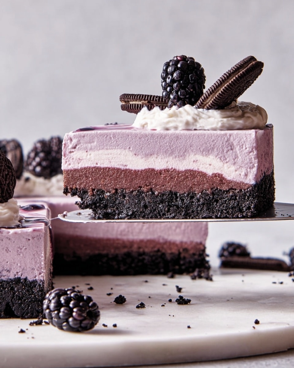 A slice of dessert is held on a spatula above a white marbled surface, showing three clear layers: a dark chocolate crumb crust at the bottom with a rough texture, a thick middle layer of smooth, light purple mousse, and a top layer of pale cream with some purple streaks, topped with a shiny black blackberry and a small piece of dark chocolate sandwich cookie. The rest of the pie on a white surface shows similar toppings with blackberries and cookie pieces scattered. Photo taken with an iphone --ar 4:5 --v 7