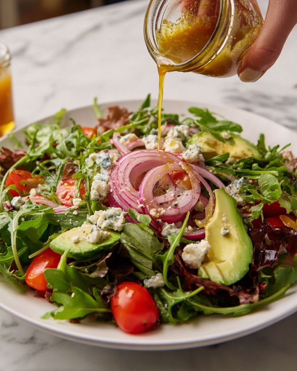 A white plate is filled with a fresh salad that has three main layers. The bottom layer is a bed of dark green arugula leaves scattered evenly across the plate. On top of the arugula, there is a mix of sliced red onions with a slightly grilled texture, light green avocado slices, and bright red halved cherry tomatoes. Small chunks of white and blue-veined cheese are sprinkled throughout this middle layer, adding texture and contrast. A woman's hand is pouring a golden brown dressing from a small clear jar above the salad, with the dressing flowing down over the layers. The plate sits on a white marbled surface. photo taken with an iphone --ar 4:5 --v 7