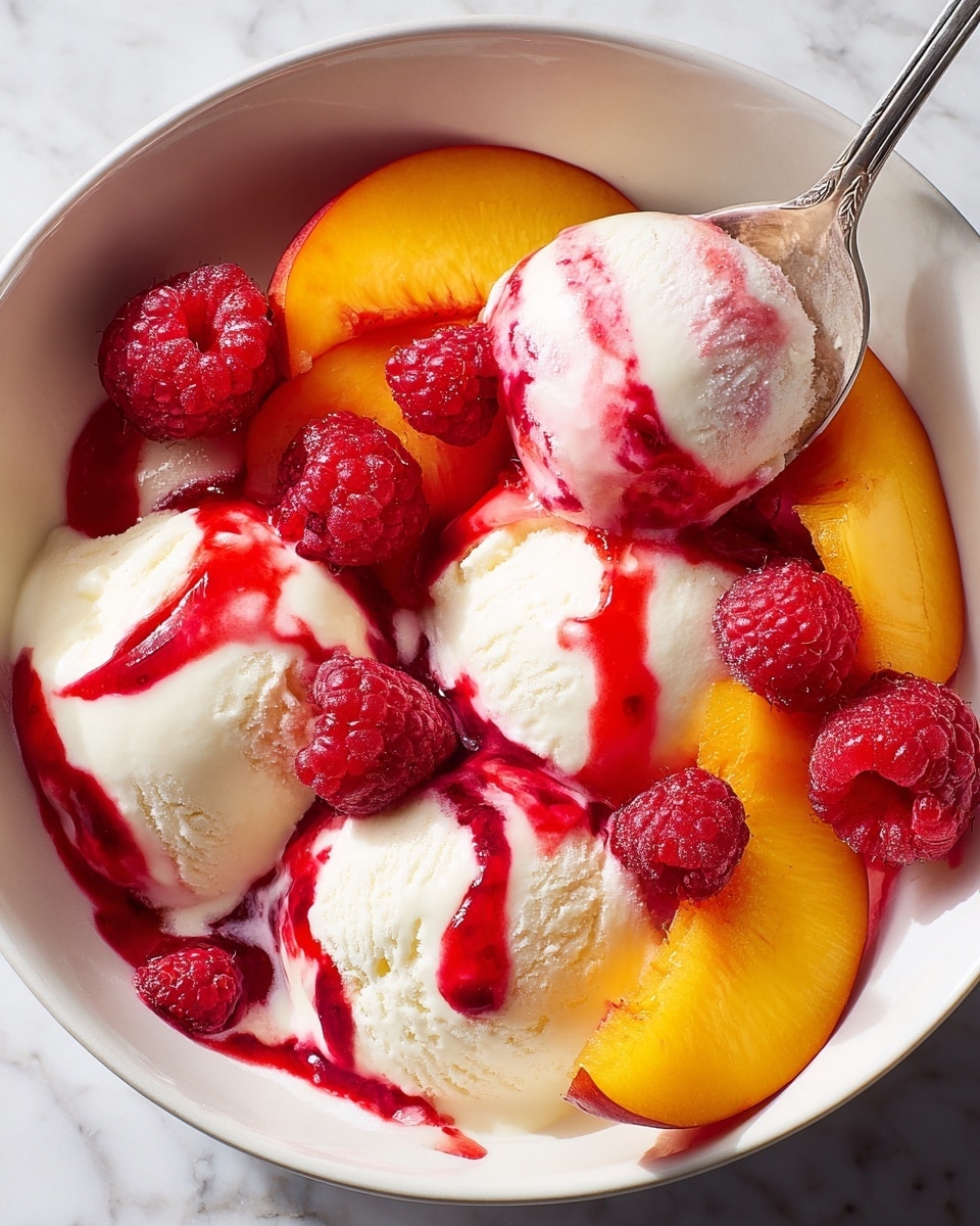 A white bowl is filled with three scoops of creamy white ice cream, topped with vibrant red raspberry sauce drizzled over them. Bright orange peach slices are arranged around the ice cream, partially covered by the sauce. Fresh red raspberries are scattered on top and around the peaches, adding texture and color contrast. A spoon holding a scoop of ice cream with sauce is lifted from the bowl, showing a mix of smooth ice cream and thick sauce. The background is a white marbled surface. photo taken with an iphone --ar 4:5 --v 7