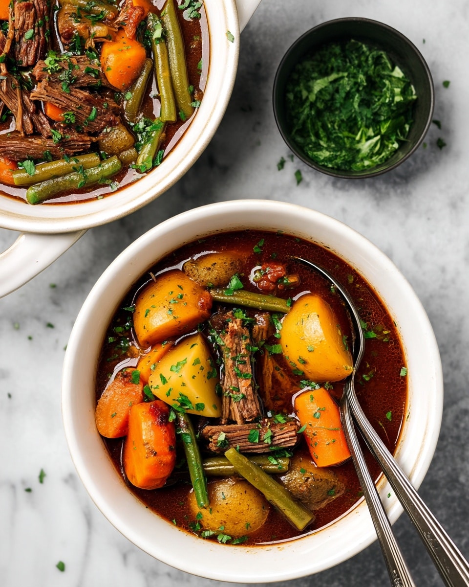 The image shows a white bowl filled with a hearty stew containing three layers of ingredients: large chunks of orange carrots, light yellow potatoes, and green beans all cooked in a rich dark brown broth. Pieces of tender shredded beef are mixed throughout, with a sprinkling of fresh chopped green herbs on top. A silver spoon rests inside the bowl on the right side. Next to the bowl is a small black container filled with more chopped herbs, all set on a white marbled surface. In the upper left corner, part of another white bowl with the same stew is visible. Photo taken with an iphone --ar 4:5 --v 7